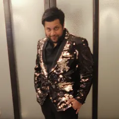 Johaan, ready for a show in a glittery jacket. We believe in looking the part, bringing a sense of style and occasion to every luxury event.