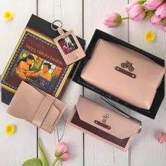 This Rakshabandhan hamper for a sister features a beautiful set of personalized vegan leather accessories in shades of pink. It includes a clutch, wallet, and a photo keychain, all with custom charms.