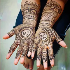For this engagement mehandi, I included the couple's initials 'VJ' in a circle on one palm and a symbol of interlocking rings on the other.