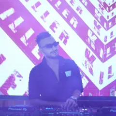 In the middle of a set, with my custom 'KILL3R' visuals on the screen behind me. The visual identity is just as important as the music for creating a memorable show.