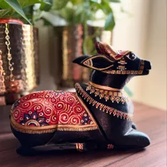 A side profile of the seated Nandi, showing the flow of the hand-painted ornamentation along its back. This piece is designed to be beautiful from every angle.