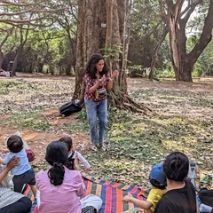 Using a small hand drum to add rhythm and sound effects to our story. This sensory element helps children connect with the story's atmosphere and pacing.