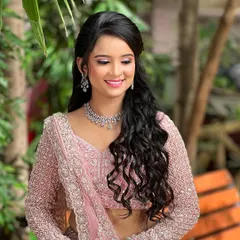 A candid, smiling shot of the engagement bride in a beautiful outdoor setting.