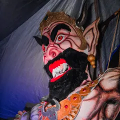 A close-up shot of the fearsome face of a Narakasura effigy, showcasing its detailed and menacing expression.