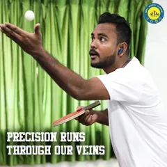 A player executes a high-toss serve with intense concentration. This level of precision is developed through dedicated practice in our air-conditioned TT zone.
