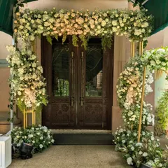 A floral archway is a classic symbol of welcome. For Andrea and Vrushank's ceremony, I designed this lush entrance with white and blush roses, creating a soft and romantic gateway for their guests.