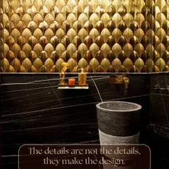 The details are not just details; they make the design. This bathroom is a testament to that, with its stunning gold fish-scale tiles, a freestanding black marble sink, and black marble walls with gold veining. It's bold, luxurious, and unforgettable.