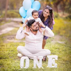 A happy family enjoying a sunny day in the park. Outdoor sessions are perfect for capturing playful and energetic moments like this fun shoulder ride.