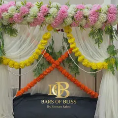This image showcases a versatile floral frame that can be used for various festive occasions. The top is adorned with pink and white flowers, while marigold garlands can be added for a traditional touch.