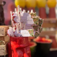Personalized paper straws and tags, continuing the '#IAMINLOVE' wedding theme across all the bar details.