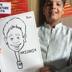 A young guest proudly shows off his black and white caricature at a party. I can add names to make each drawing extra special.