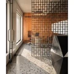For a construction firm's office, we used reinforced steel bars, a common building material, to create a delicate and visually permeable screen that separates the reception from the conference area.