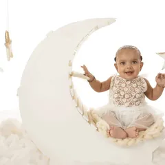 "Fly me to the moon." This dreamy sitter session setup with a moon prop and fluffy clouds is perfect for capturing your baby's magical spirit.