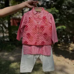 This pink kurta set comes with a beautifully quilted Nehru jacket featuring a floral print. It's a classic and charming look, perfect for making your little boy stand out at any festive event.
