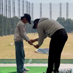 It all starts with the right foundation. Here, one of our coaches is teaching a junior player the correct way to hold the club, ensuring good habits from the very beginning.