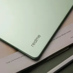 A detailed shot focusing on the sleek corner and branding of the realme Pad 2, emphasizing its premium build quality.