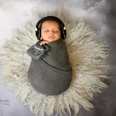 This tiny DJ is sleeping on the job. Swaddled in grey with miniature headphones, this is a fun and modern concept for music-loving families.