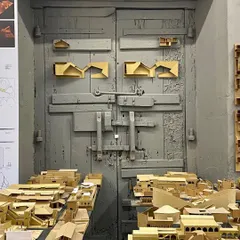 Physical models, like these from a student workshop, are essential tools for understanding three-dimensional space. They make the architectural idea tangible, showing how different forms come together to create a whole.