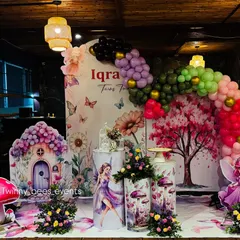 We brought a fairy garden to life for Iqra's birthday. This enchanting setup includes a custom backdrop with floral and butterfly details, a fairy house cutout, and a colorful balloon arch to create a magical atmosphere.