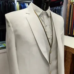White suits are anything but boring when designed with the right details. This crisp white three-piece suit features subtle gold piping and buttons, offering a sharp and sophisticated look.