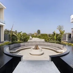 This wide view captures the relationship between the architecture and the landscape. The home's modern wings frame the central courtyard, where the sunken lounge and water feature create a focal point for relaxation and social gatherings during the day.