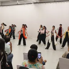A group of my adult students performing their Bollywood routine for a cheering audience at our showcase. It's amazing to see their hard work pay off in such a joyful performance.