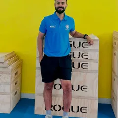 Posing with plyometric boxes at a high-performance coaching course. Investing in my own education ensures that the training programs I design are based on the most current and effective methods.