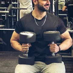Strength isn't just about lifting weights; it's about lifting yourself up every day. Here I am with a set of heavy dumbbells, ready for a chest press session.