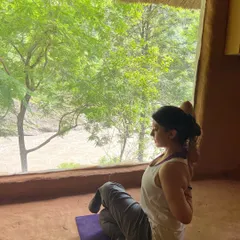 Practicing a seated twist, a photo from my late 30s. My personal practice has evolved over the decades, but the core principles of breath and alignment remain constant.