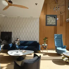 The front elevation of the Screen House is designed to flood the interiors with natural light. Strategically positioned screens provide privacy while allowing seamless ventilation, achieving a perfect balance of openness and comfort in this living area.