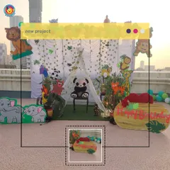 For this jungle-themed birthday, I created a safari camp on a rooftop. The setup included a teepee tent, numerous animal cutouts like elephants and lions, and a custom "Happy Birthday" sign made from a log prop.