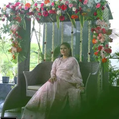 A candid moment captured at the baby shower. The floral decor provides a soft and beautiful background for these precious memories.