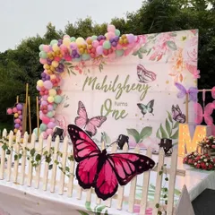 This beautiful butterfly-themed first birthday setup features a custom floral backdrop, a pastel balloon garland, and large, eye-catching butterfly cutouts for a magical garden party feel.