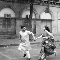 A playful, spontaneous moment captured in black and white against the classic architecture of Mumbai. This pre-wedding photo shows our ability to find romance and fun in urban landscapes, telling a story that feels both timeless and modern.