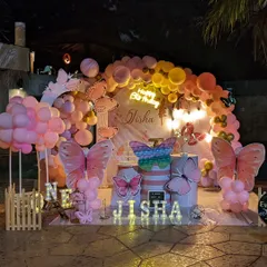 This enchanting butterfly theme was perfect for a first birthday party. We used a soft pastel balloon arch, large butterfly cutouts, and marquee lights with the birthday girl's name to create a whimsical garden feel.