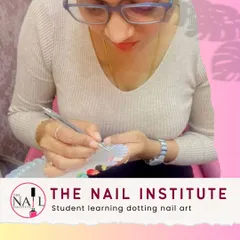 A student practices creating designs with a dotting tool, learning how to make patterns of various sizes and shapes.