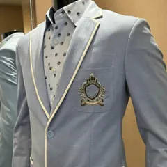 A closer look at another one of our breathable jackets. This light blue piece with cream piping and a custom crest is perfect for looking sharp without feeling weighed down.