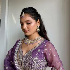 A closer view of the soft glam makeup. The focus is on flawless skin and subtly defined eyes, paired with a half-up hairstyle that is both elegant and modern.