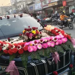 Here is a close-up of a floral arrangement on a black Mahindra XUV. I used a dense line of red, pink, and white flowers with green ferns for a bold and contrasting look.