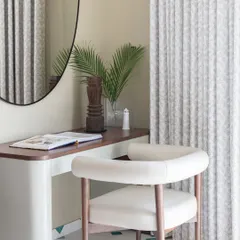 Amidst the tranquil sanctuary of this bedroom lies a wondrous alcove. I designed this cozy study corner to be a space where creativity blossoms and dreams take flight, anchored by a simple desk and a comfortable chair.