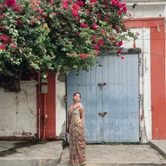 Posing against a charming, colorful doorway in French Pondicherry. I am available for travel and have experience shooting in various cities to match a brand's specific creative vision.