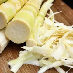 Preparing fresh bamboo shoots for pickling. The process involves carefully slicing the tender shoots to get the perfect texture for the final product.