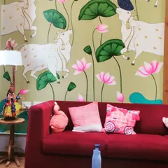 This Pichwai wall art brings a traditional and serene feel to a modern living room. The repeating motif of cows and lotuses on a soft green background complements the contemporary furniture beautifully.