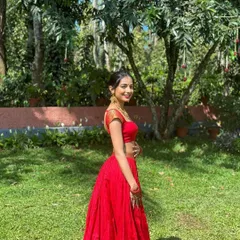 A side profile of the red crop top and skirt set, showing how the simple, clean lines create a flattering silhouette. The focus here is on the perfect fit and the vibrant color.