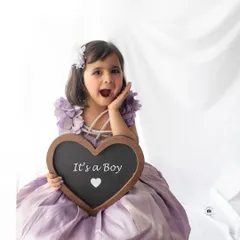 A creative and adorable way to announce a new arrival. This little girl's surprised expression is priceless as she shares the "It's a Boy" news.