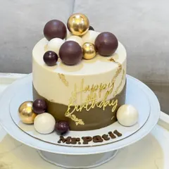 A full view of the modern olive green and ivory cake on a stand, personalized with "Mr. Patil" in chocolate. This shows how the design comes together for a sophisticated celebration.