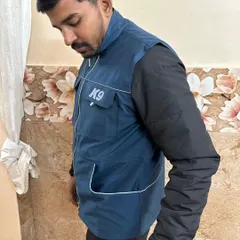 A side view of the blue K9 trainer vest, showing the clean lines and the placement of the front hand pockets. The material is tough enough for daily use but light enough that you'll barely notice you're wearing it.
