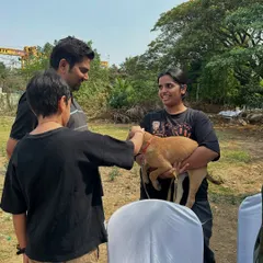 A potential adopter meets a gentle tan puppy at our Pawsome Heroes drive. These first interactions are so important. It's where families can feel a connection and see an animal's true personality shine.