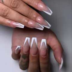I took the classic V-French and gave it a party-ready upgrade. This set features a glittery cat eye base under sharp, clean white tips for a dramatic effect.
