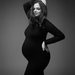 Classic and timeless. This black and white portrait in a simple, form-fitting dress focuses on the beautiful curves and confident pose of the mother-to-be, creating a powerful and elegant image.